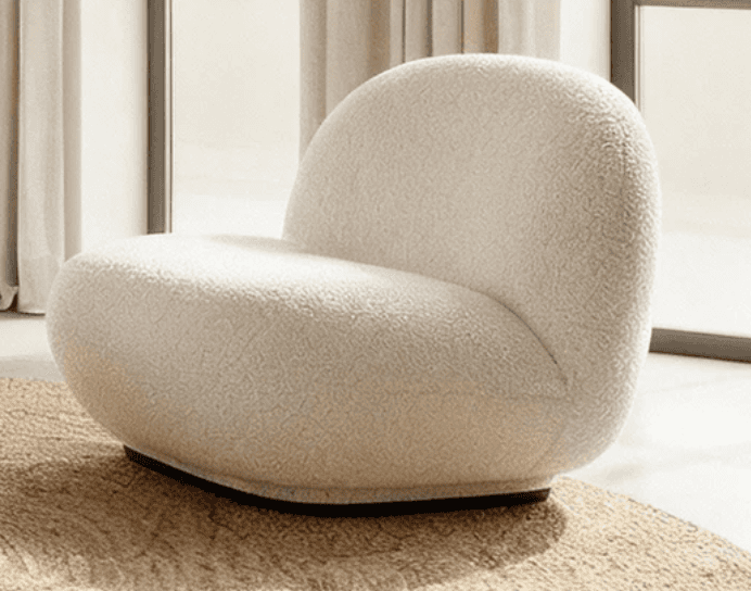 An armless lounge chair upholstered in a cream-colored boucle fabric, featuring a rounded, organic s… — 3D model