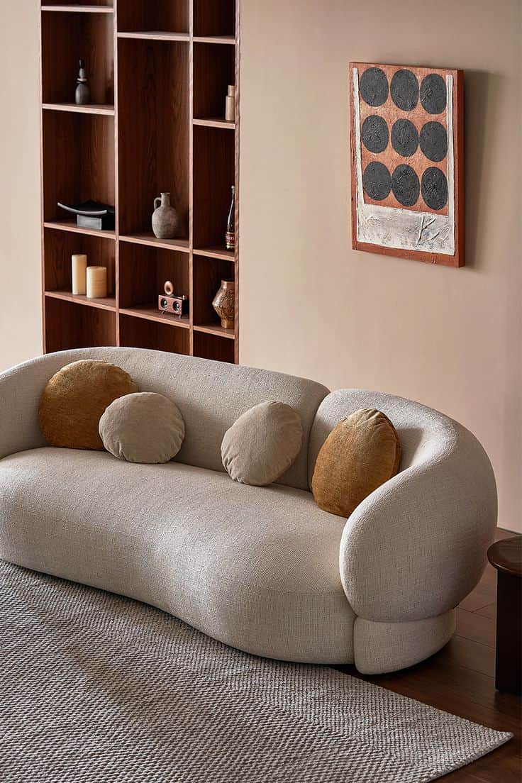 A contemporary curved sofa featuring a fluid, organic silhouette, fully upholstered in a light beige… — free GLTF 3D model