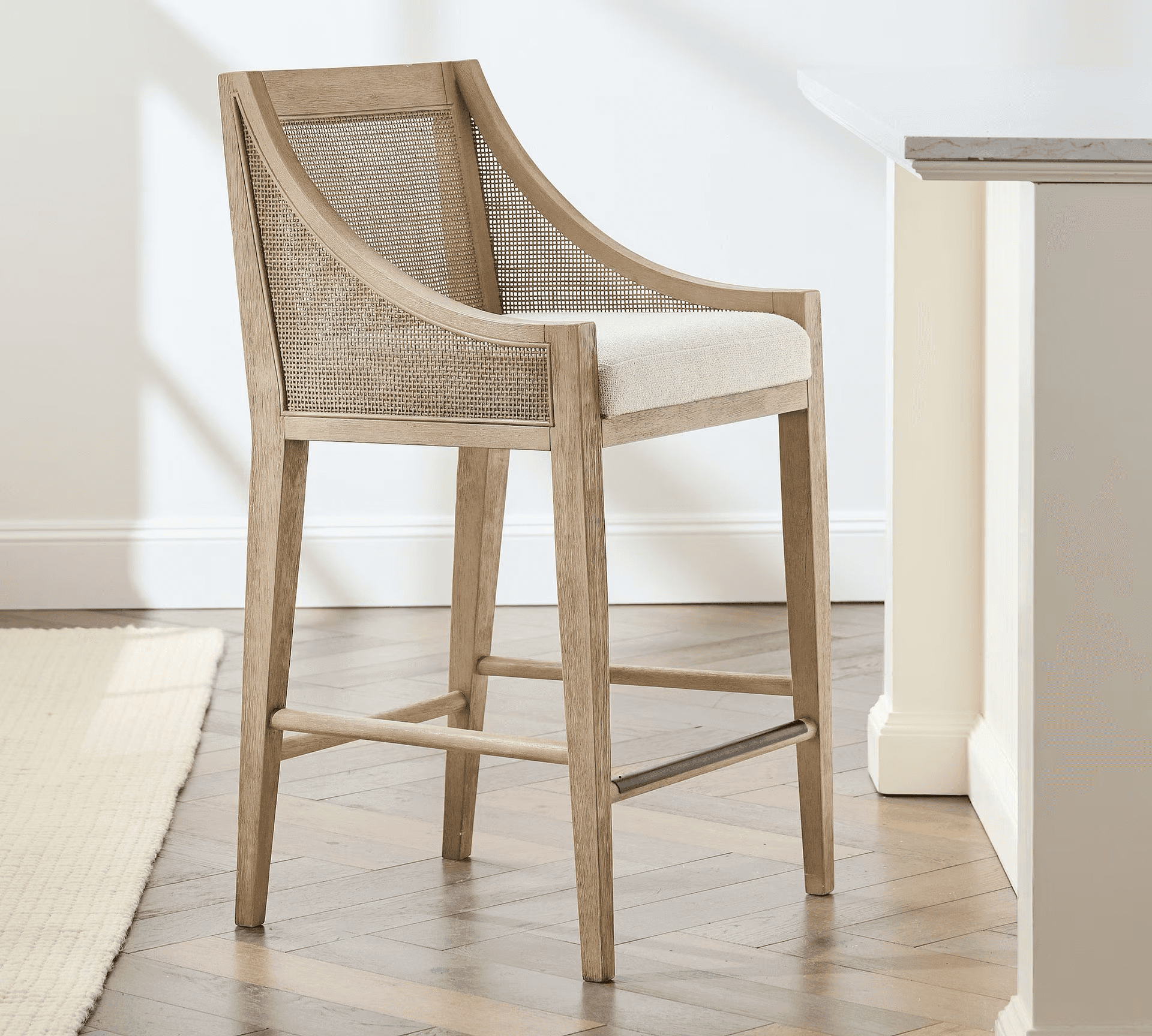 A wooden bar stool with a woven cane back and a cushioned seat. The stool features a gently curved b… — 3D model