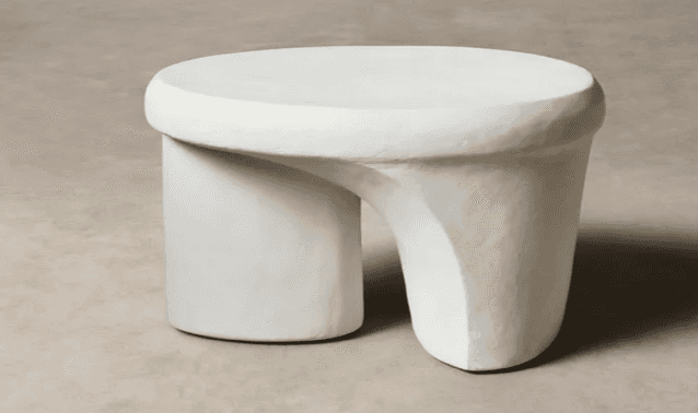 An off-white sculptural table with a rounded top and a distinctive, asymmetrical, and curved base, f… — 3D model