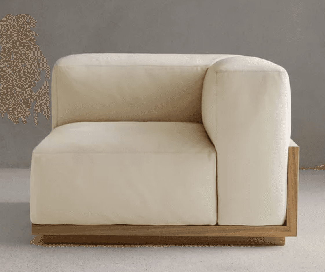 A modern modular corner armchair with a light cream upholstered finish and a visible natural wood ba… — 3D model