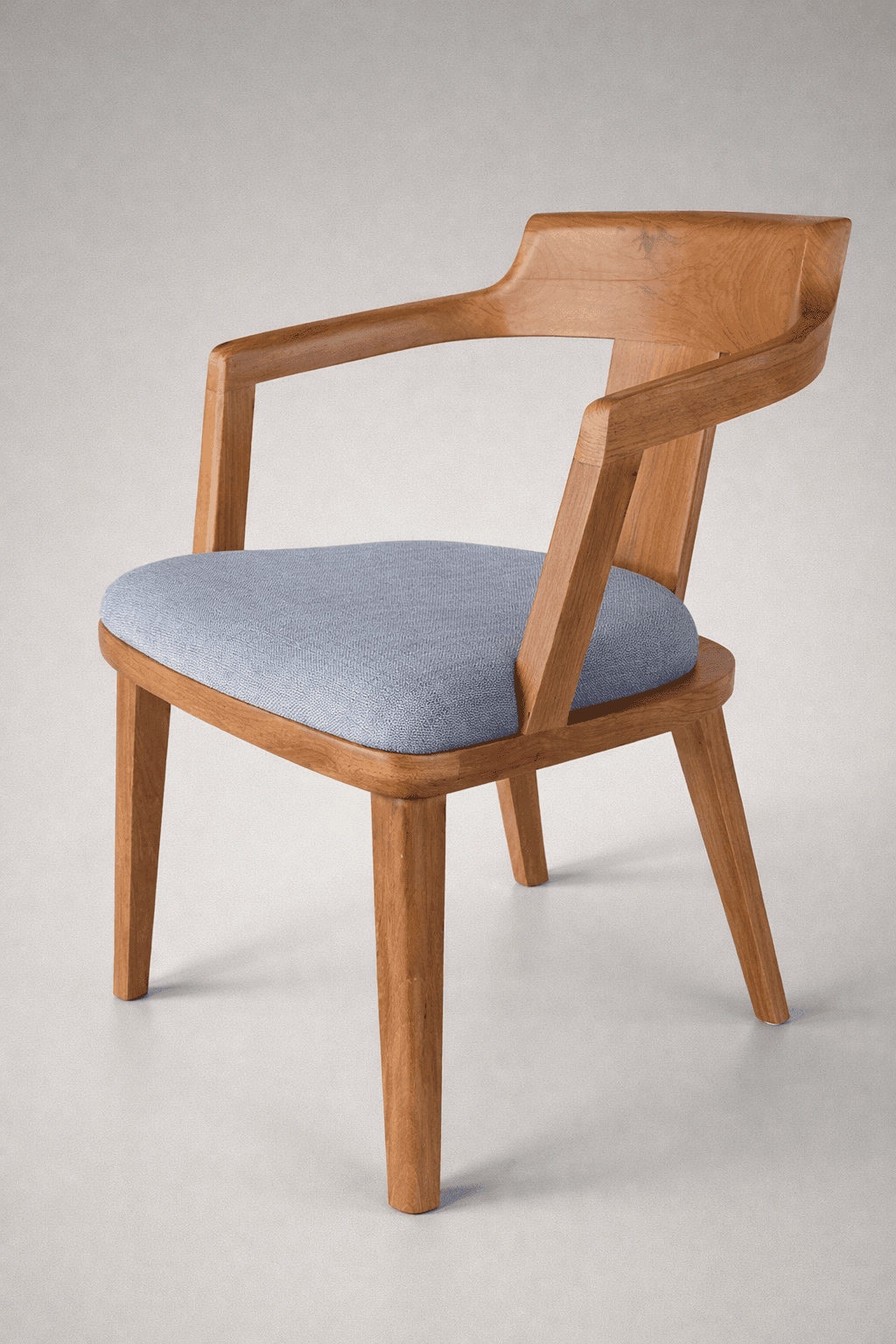 A wooden armchair with a padded seat. The chair features a distinctive curved backrest that flows in… — free OBJ 3D model