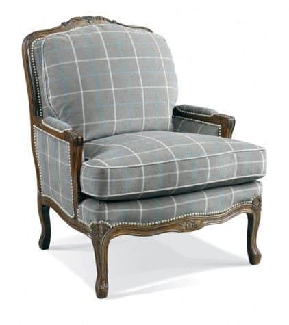 A wingback armchair with a carved wooden frame and upholstered seat, back, and arms in a grey plaid… — 3D model