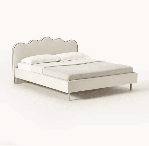 A queen-sized bed frame with a padded headboard and footboard, upholstered in a light beige fabric.… — 3D model
