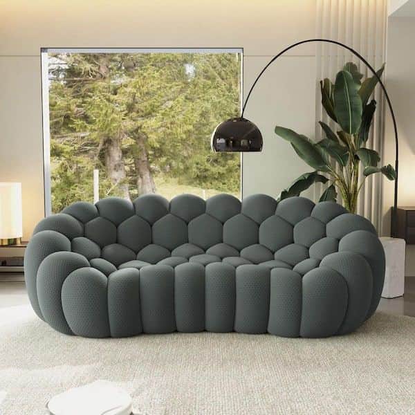 A contemporary grey upholstered sofa featuring a distinctive bubble-like design where the entire sur… — free BLEND 3D model