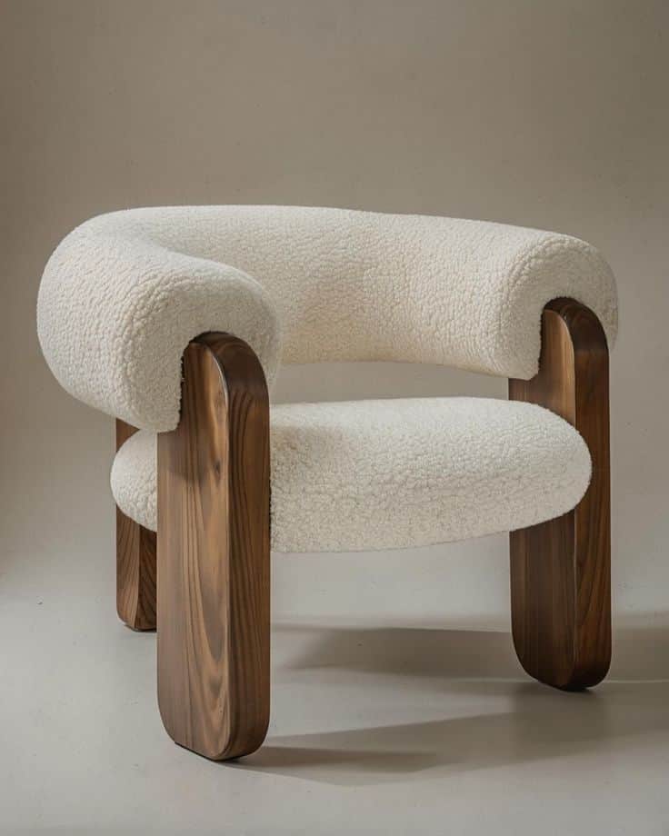 A low-profile lounge chair featuring a thick, rounded seat and back upholstered in white bouclé fabr… — 3D model