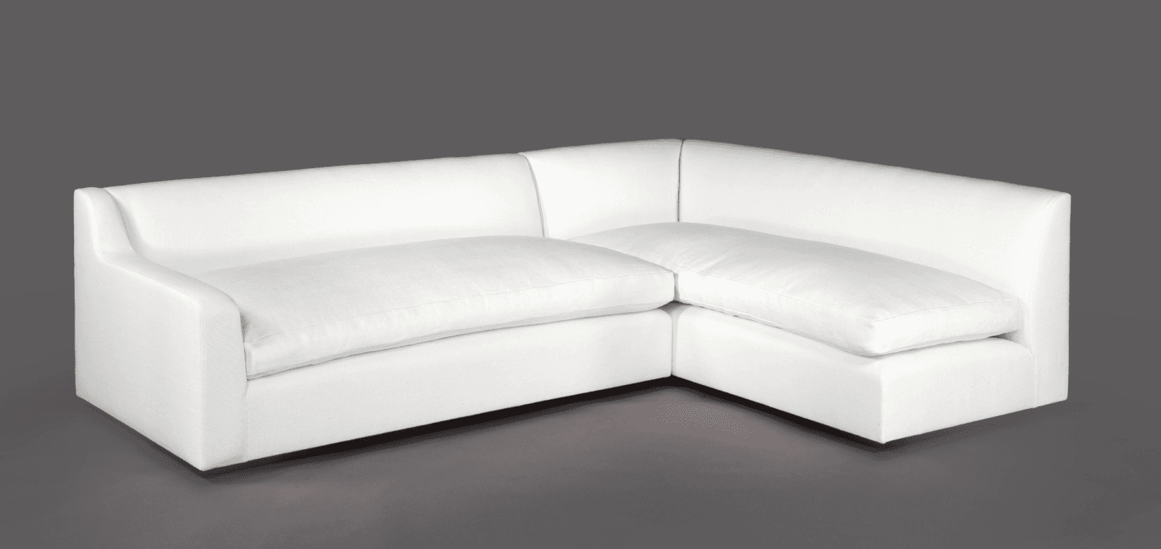 A white L-shaped sectional sofa with deep seating and clean lines. The sofa features a low profile w… — 3D model