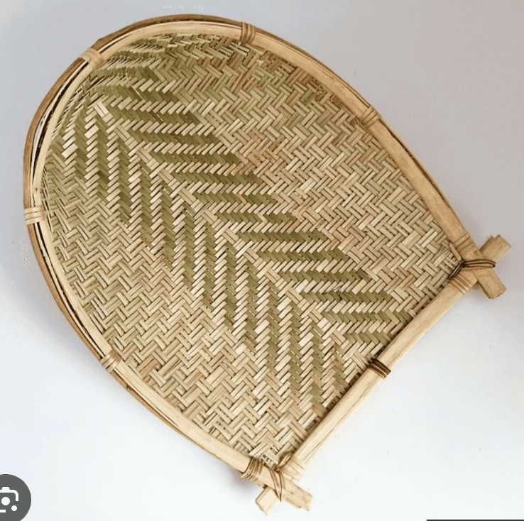 A traditional handwoven bamboo winnowing basket, characterized by its shallow, scoop-like form with… — 3D model