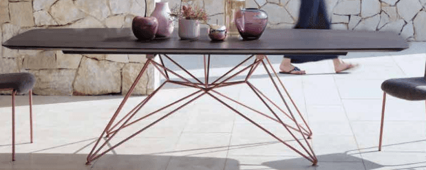 A rectangular coffee table with rounded corners, featuring a dark brown top and a delicate, wirefram… — free BLEND 3D model