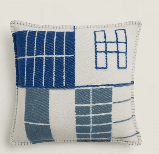 A square cushion with a geometric pattern composed of blue and white squares and rectangles, with so… — 3D model