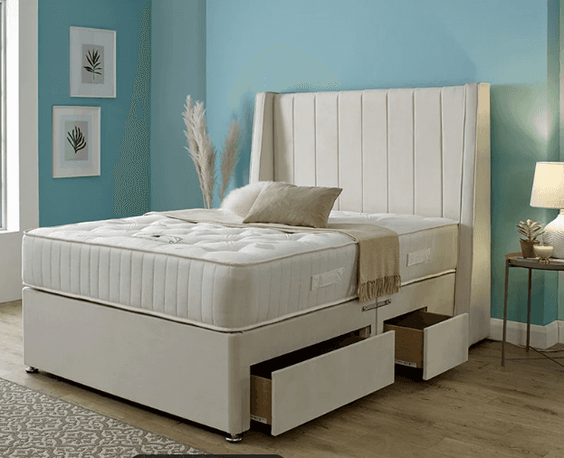 A contemporary upholstered divan bed featuring a tall, winged headboard with vertical channel tuftin… — 3D model
