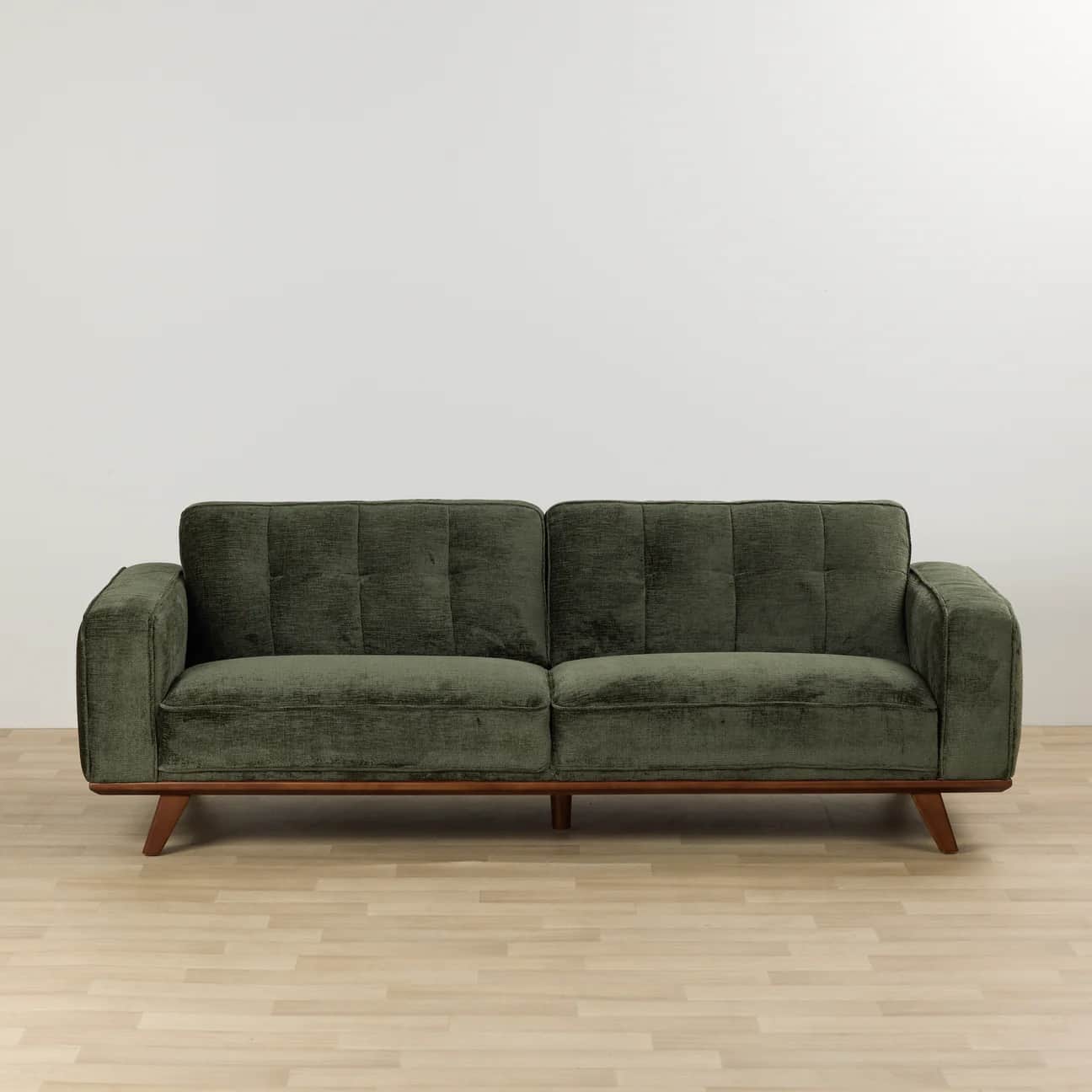 A two-seater sofa with green fabric upholstery, featuring tufted back cushions, square track arms, a… — 3D model