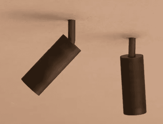 Two dark, cylindrical light fixtures mounted to a ceiling. One is angled downwards, and the other is… — 3D model