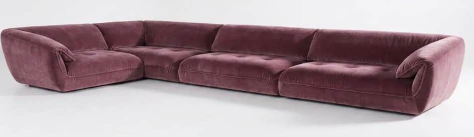 A large L-shaped modular sectional sofa upholstered in plush mauve velvet. It features a low profile… — 3D model