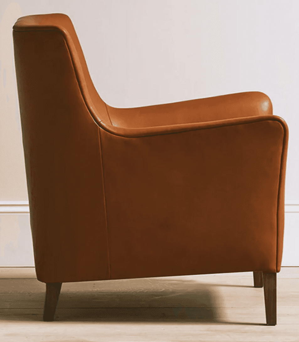 A contemporary armchair upholstered in cognac-colored leather, featuring a broad seat, low-profile r… — 3D model