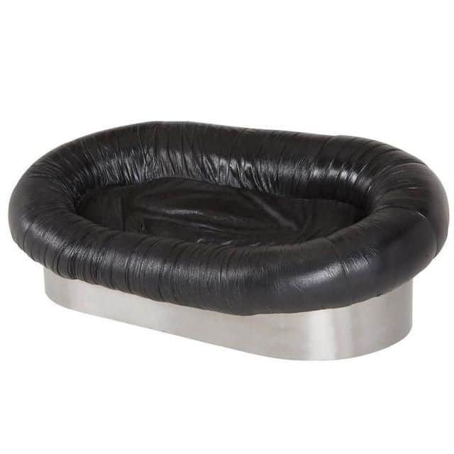 A low-profile sofa with an oval-shaped silhouette. The upholstery features a tufted or gathered effe… — free GLTF 3D model