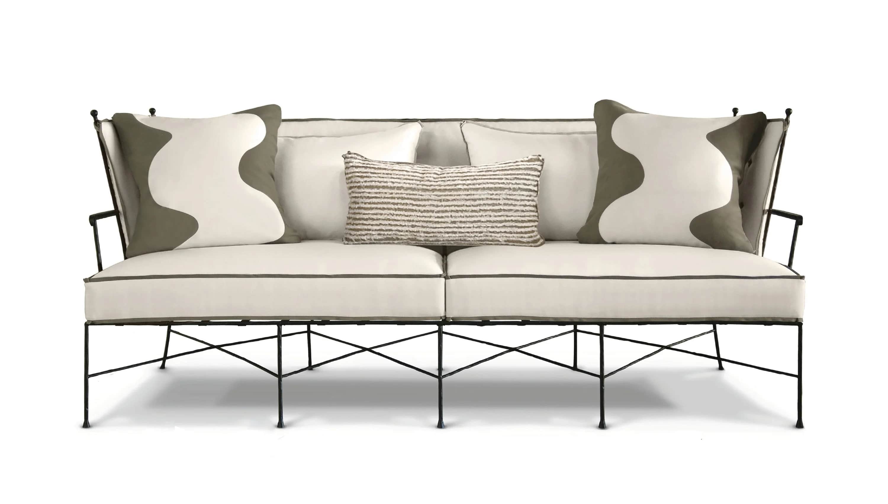A contemporary sofa with a black metal rod frame, off-white upholstered cushions, and decorative thr… — 3D model