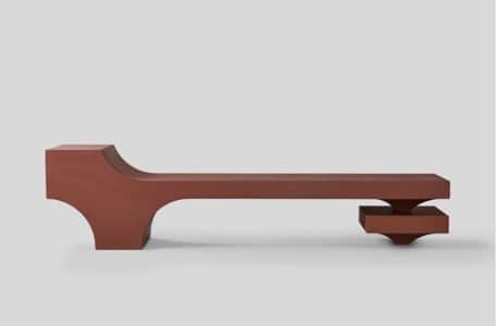 A long, minimalist bench featuring a reddish-brown (terra cotta-like) hue and a distinct sculptural… — 3D model