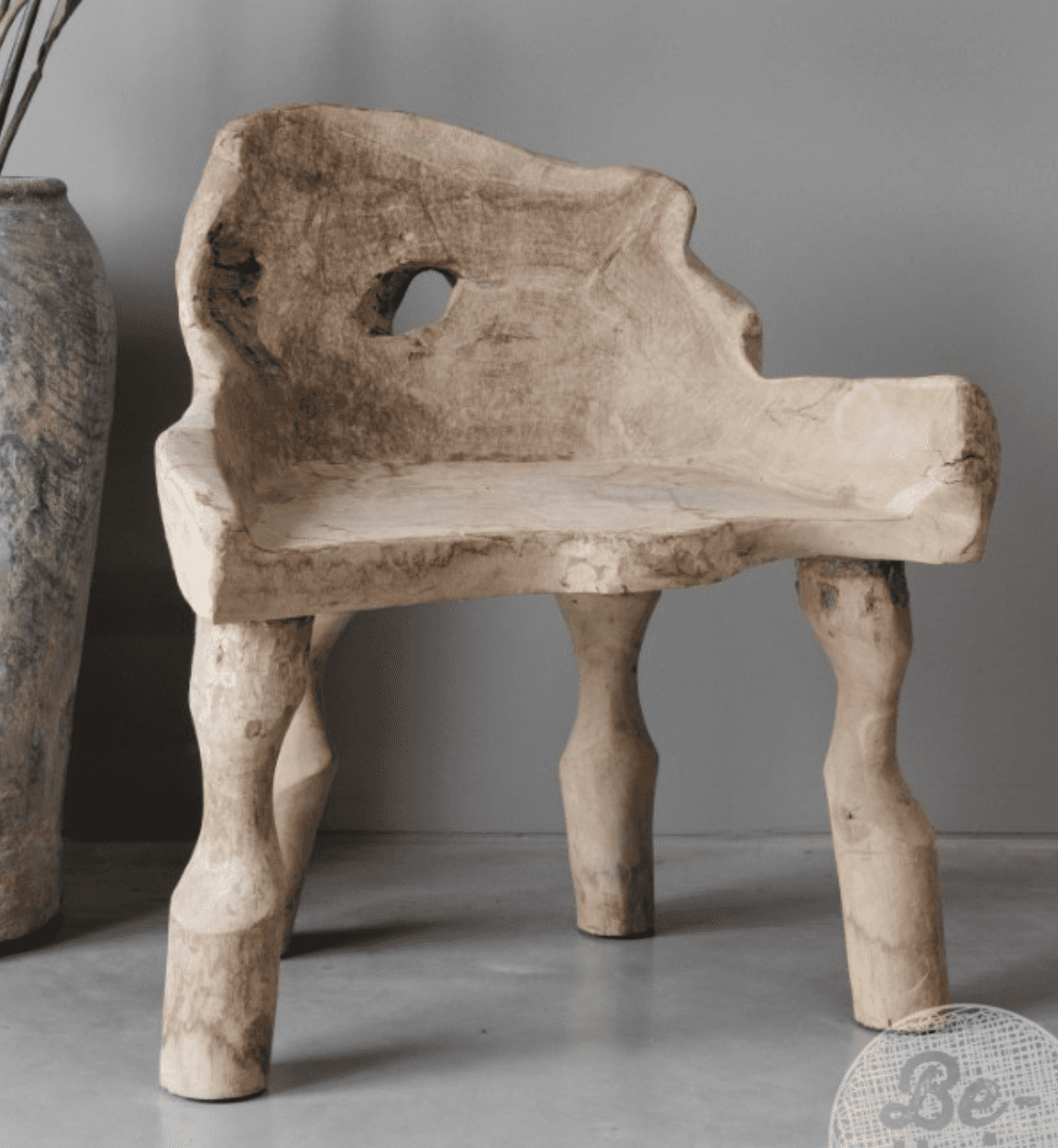A unique lounge chair carved from a single piece of weathered, light-colored wood, likely teak or a… — 3D model
