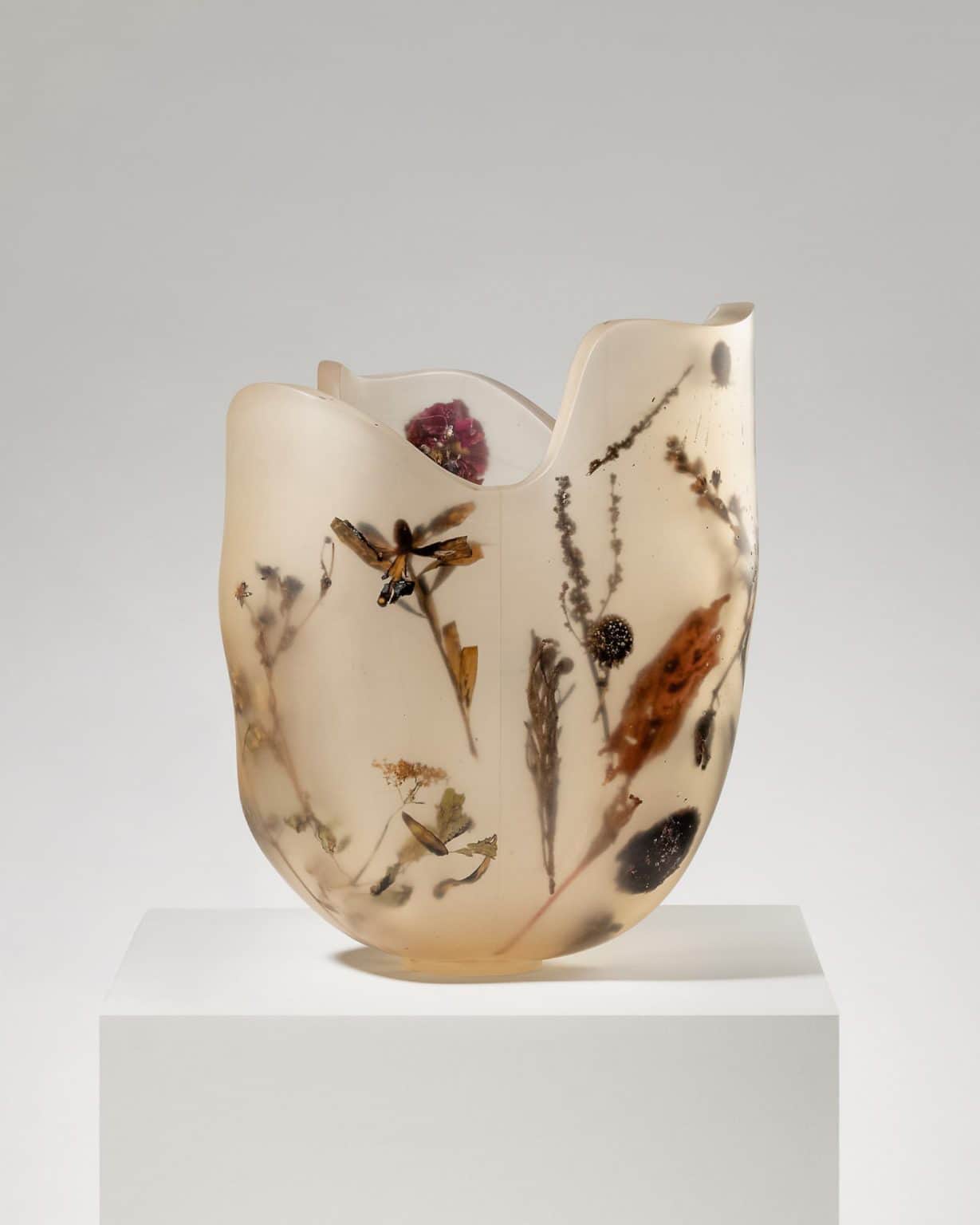 A translucent decorative vessel, likely a vase, crafted from resin with dried botanical elements suc… — 3D model