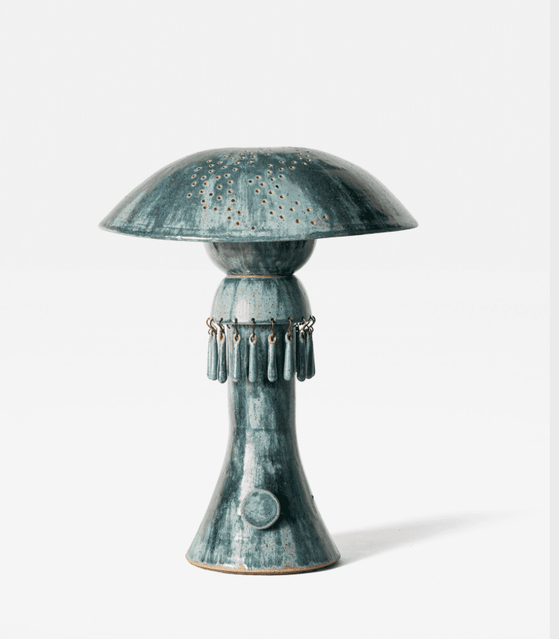 A ceramic table lamp featuring a distinctive mushroom-shaped shade with an array of small perforatio… — 3D model