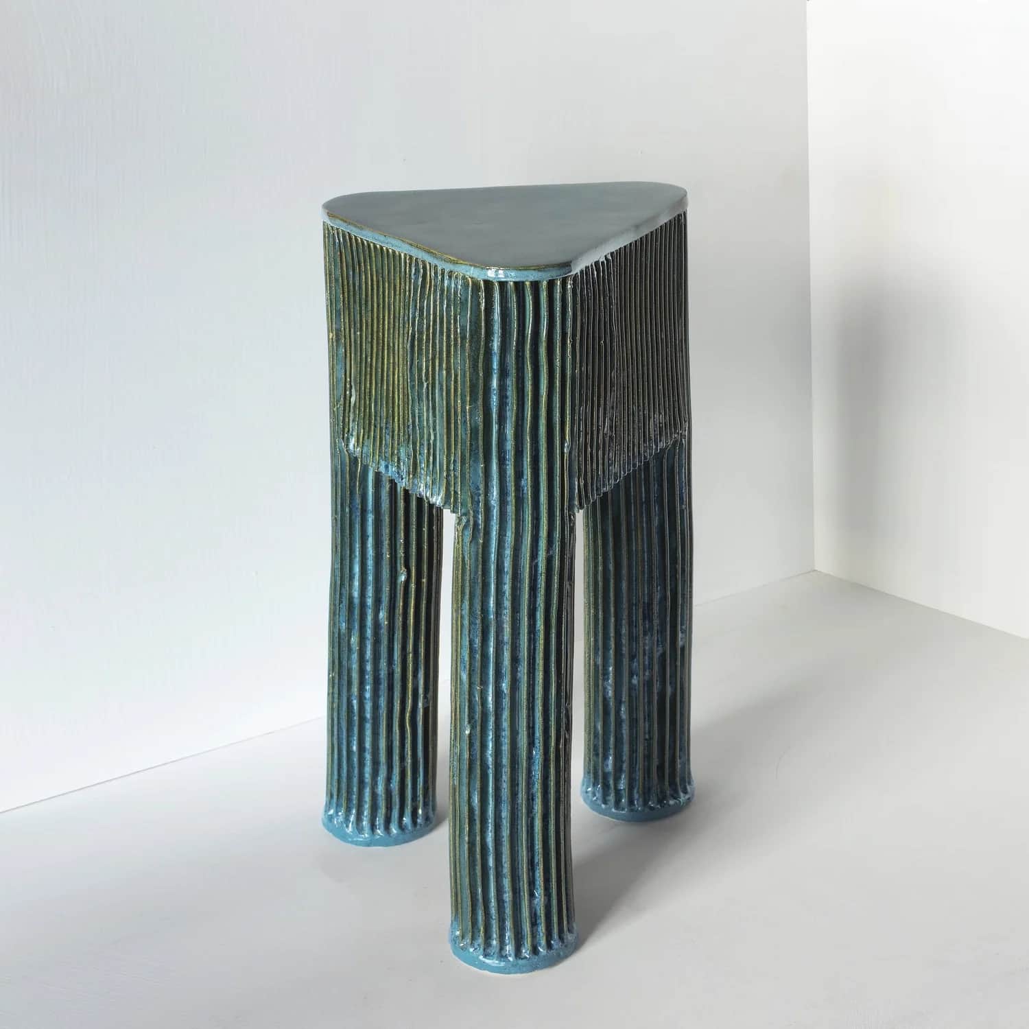 A striking accent table with a unique triangular top and three supporting columnar legs. The entire… — free STL 3D model