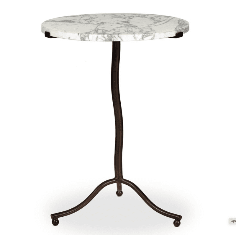 A small, round accent table featuring a white marble top with prominent grey veining, supported by a… — 3D model
