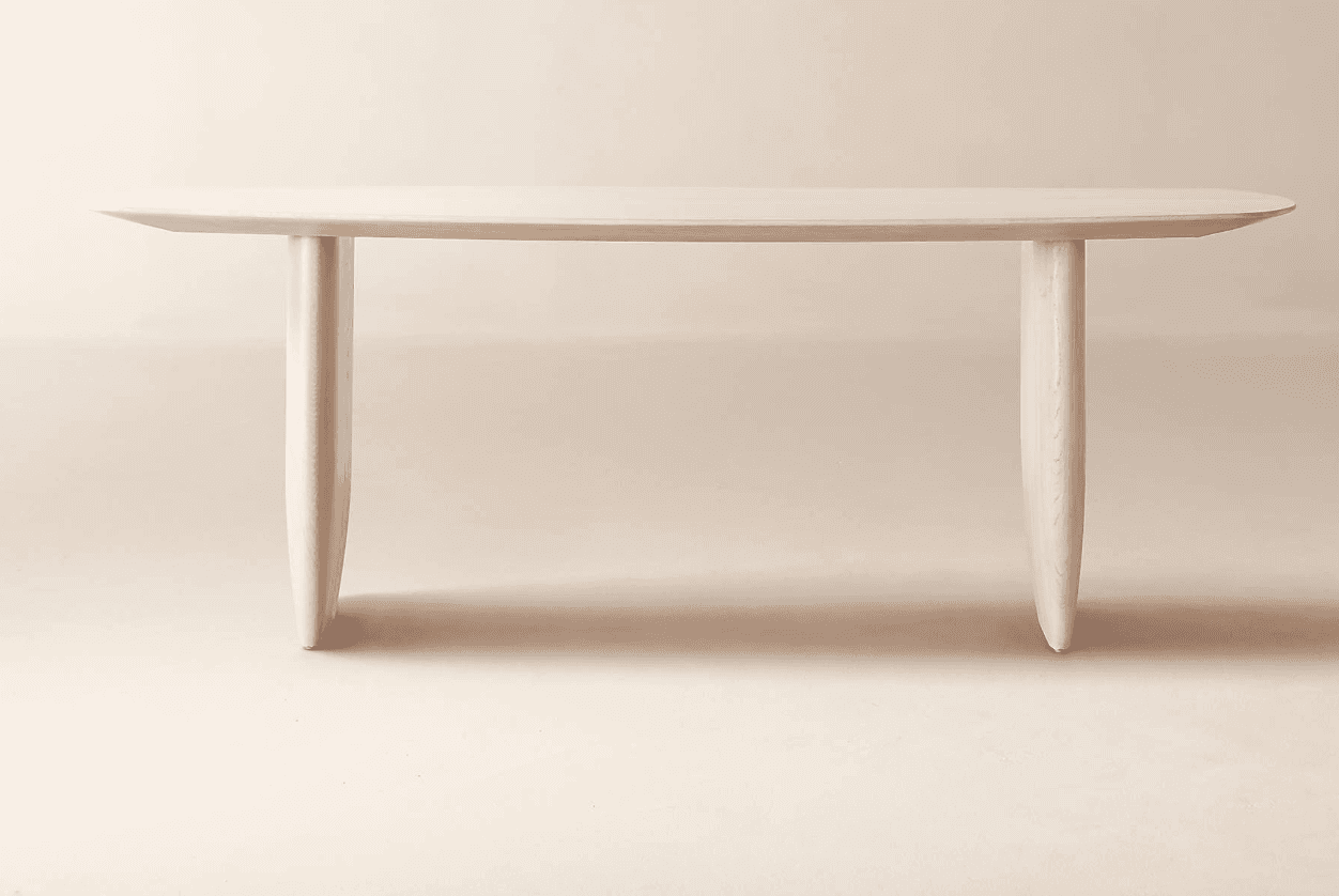 A minimalist console table featuring an elongated oval tabletop supported by two thick, sculptural,… — 3D model