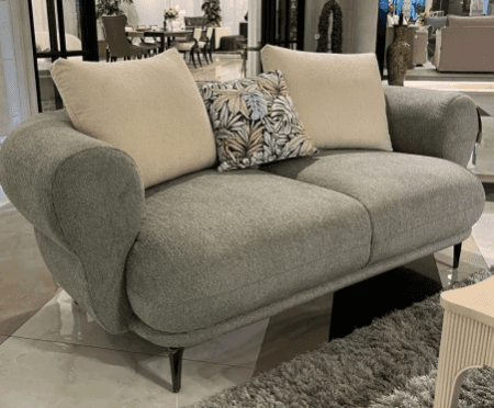 A contemporary two-seater loveseat with a rounded silhouette, upholstered in a textured sage green f… — 3D model