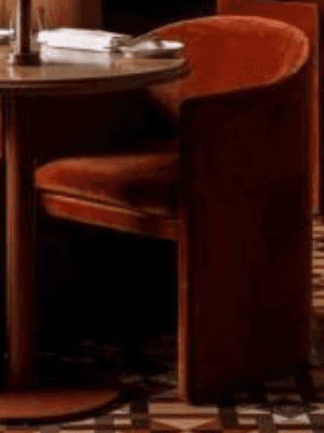A modern barrel-shaped armchair, fully upholstered in a rust-colored velvet-like fabric. The chair f… — 3D model