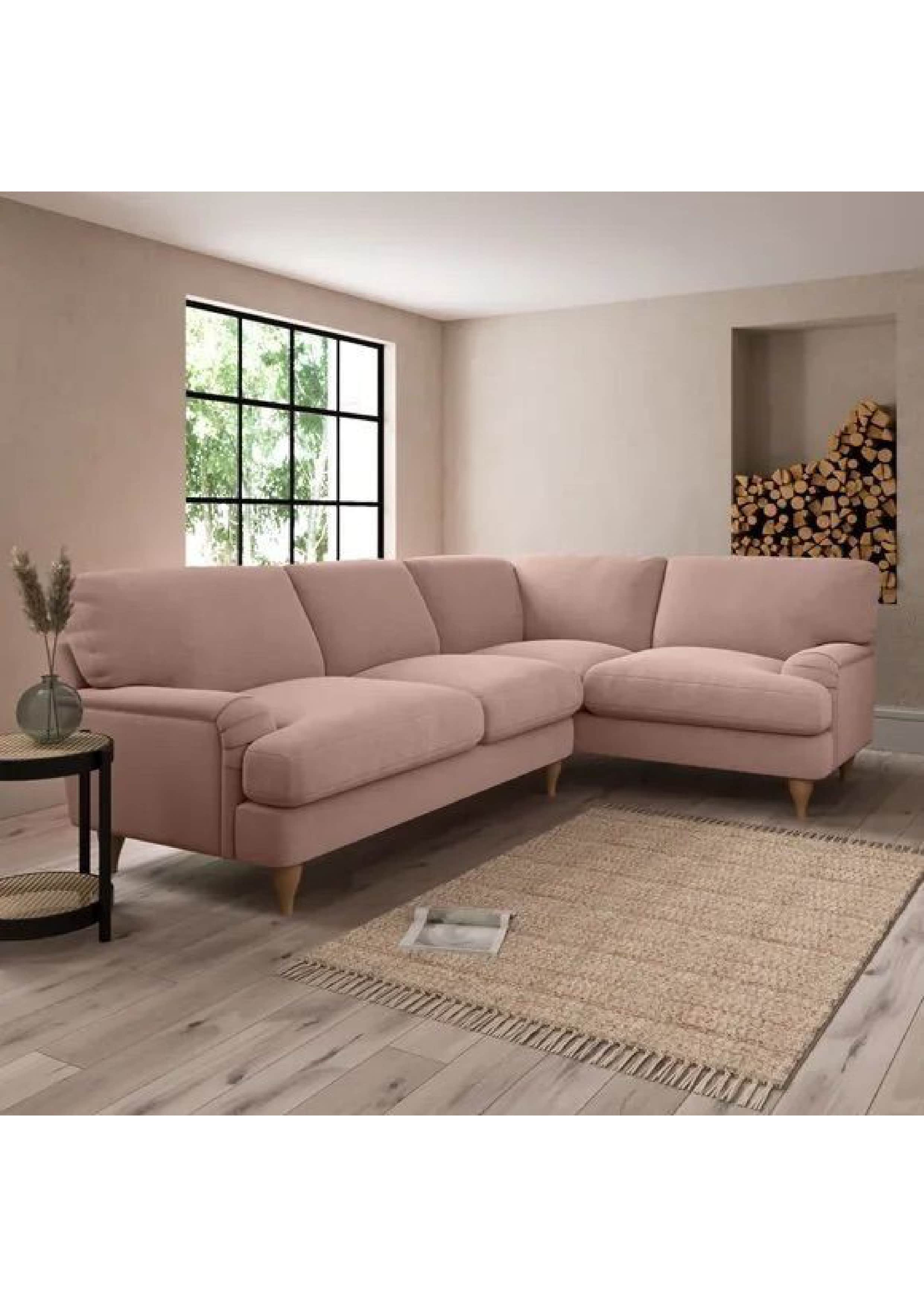 This is an L-shaped sectional sofa featuring light pink upholstery, plush seat and back cushions, an… — 3D model