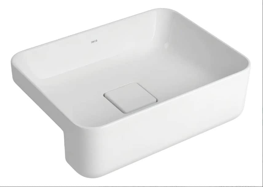 A white, rectangular vessel sink with smooth, rounded edges. It features a central drain cover with… — 3D model