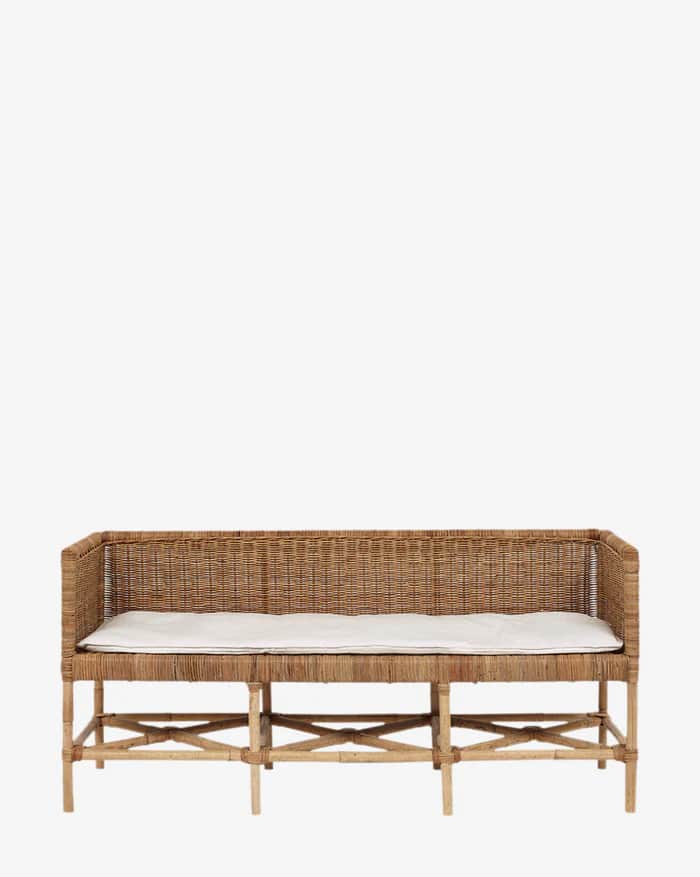 A rustic bench constructed from woven rattan or wicker, featuring a slatted base with X-shaped braci… — 3D model
