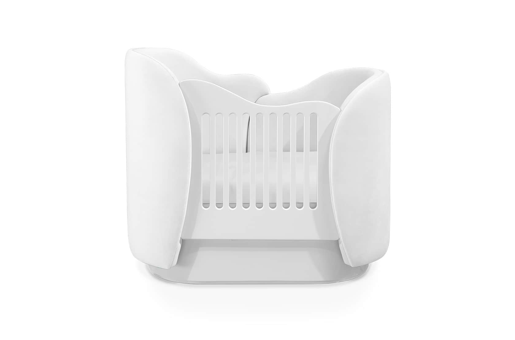 A modern, all-white infant crib featuring a distinctive oval shape and curved side panels that exten… — 3D model