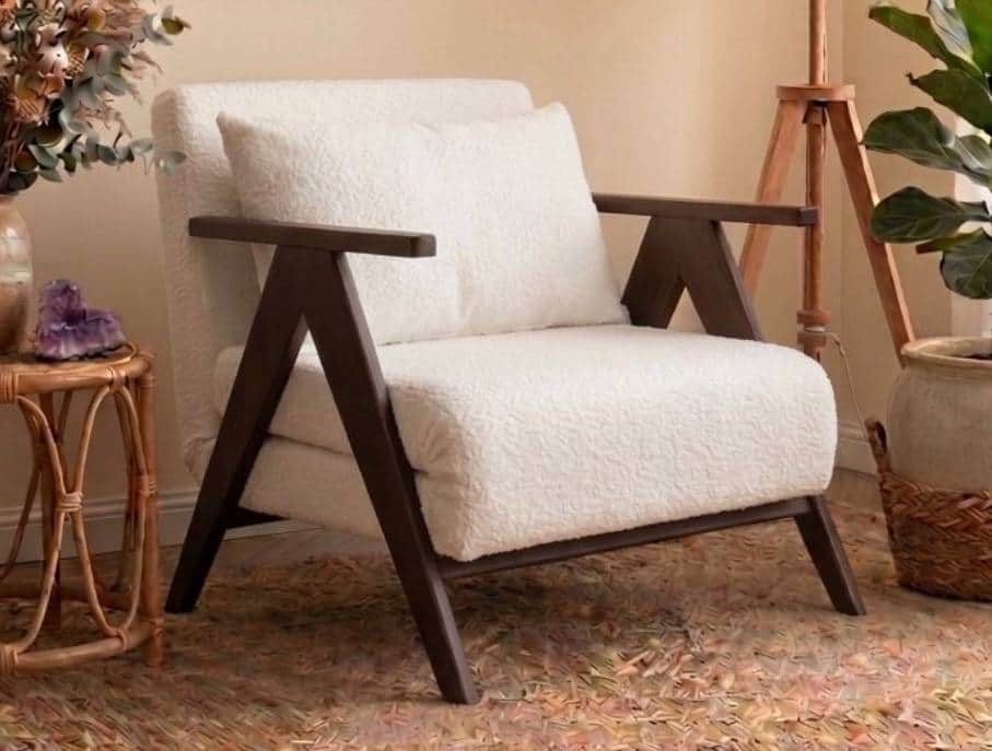 A modern lounge chair featuring a prominent dark wood frame and plush, off-white bouclé upholstery.… — free STL 3D model