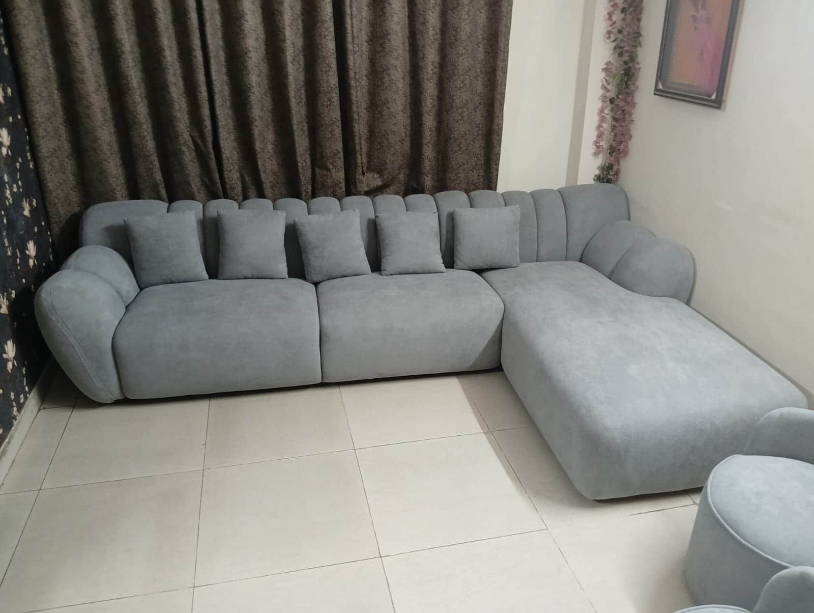 A modern light grey fabric sectional sofa featuring a modular design with a prominent chaise lounge… — 3D model