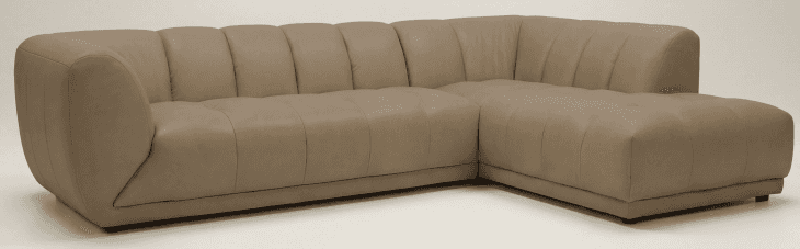 A modern sectional sofa upholstered in taupe leather, featuring distinct channel tufting on the back… — free SKP 3D model