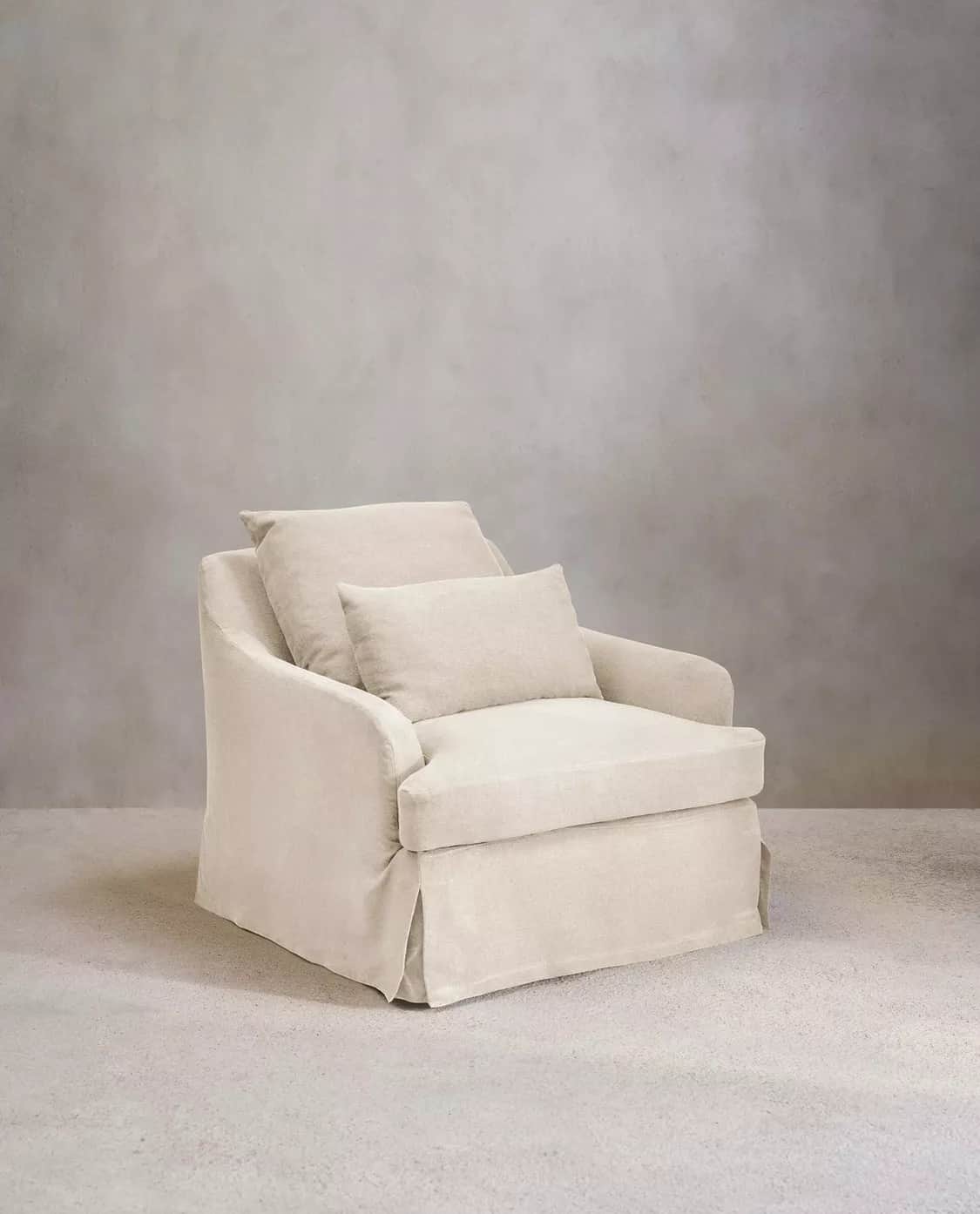 A slipcovered armchair with a plush, inviting appearance. The armchair features a skirted base and t… — free OBJ 3D model