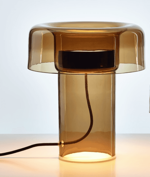A modern table lamp constructed primarily from smoked amber glass. The design features a cylindrical… — free OBJ 3D model