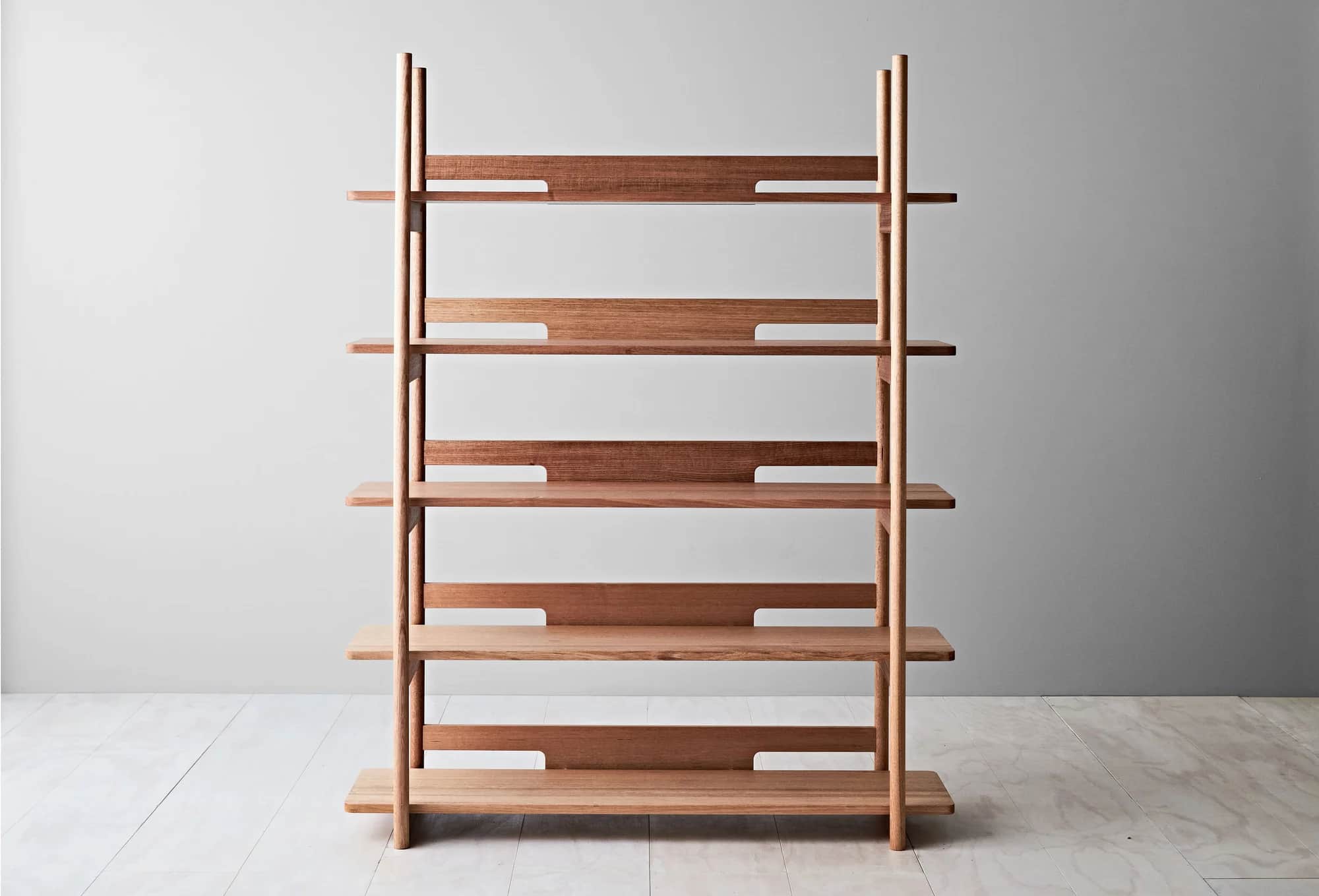 A wooden bookshelf with a minimalist design. It features vertical supports and multiple horizontal s… — 3D model