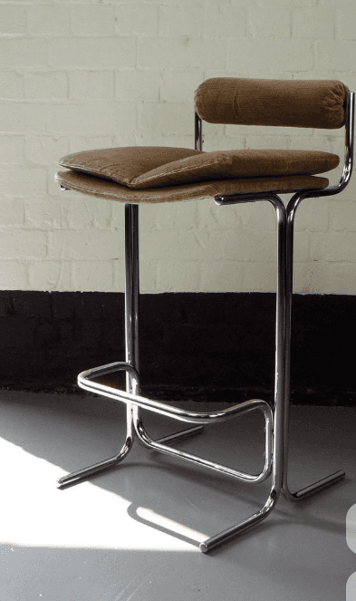 A bar stool with a chrome-plated metal frame and a cushioned seat and backrest. The seat and backres… — free SKP 3D model