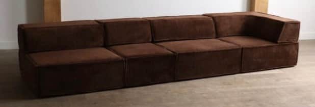 A contemporary modular L-shaped sectional sofa rendered against a white background. The sofa is comp… — 3D model