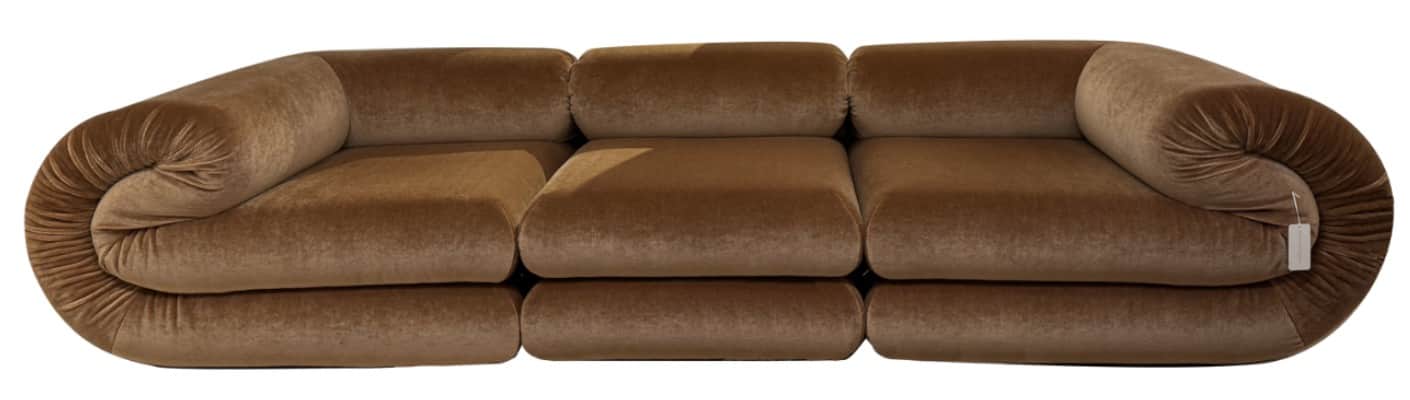 A modular sofa with a distinctive rounded armrest on the left side and a bolster-style armrest on th… — 3D model