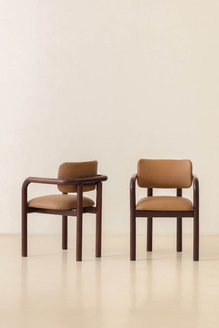 Two armchairs with wooden frames and upholstered seats and backrests. The frames have a rounded, tub… — 3D model