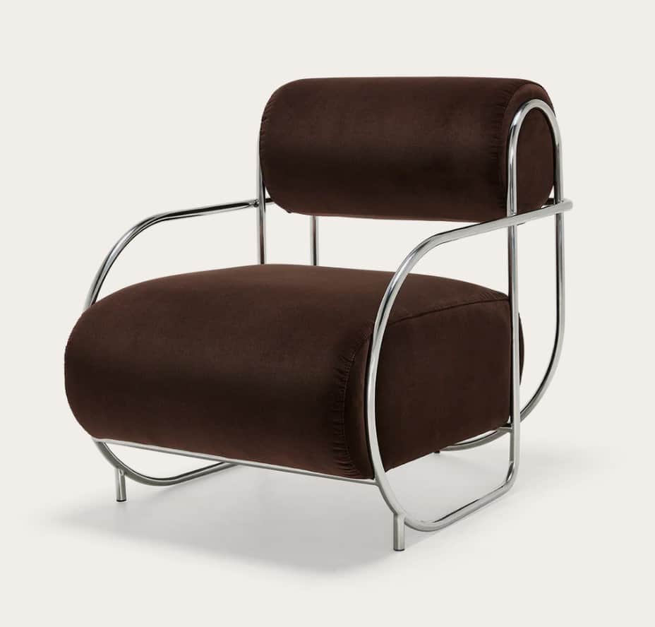 A modern armchair featuring a curved tubular metal frame with a polished chrome finish. The seat, ba… — free GLTF 3D model