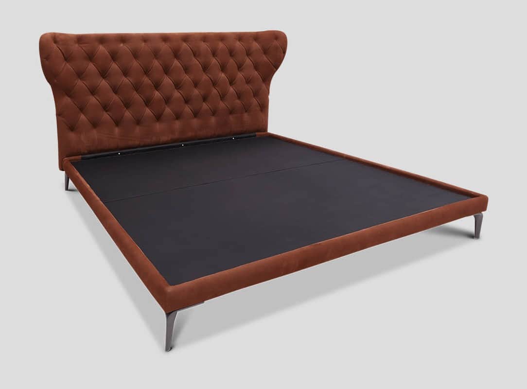 A tufted bed frame with a winged headboard, upholstered in a rust-colored fabric. The headboard feat… — free BLEND 3D model