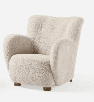 A plush armchair upholstered in a textured, sheepskin-like fabric. It features a high, slightly curv… — free OBJ 3D model