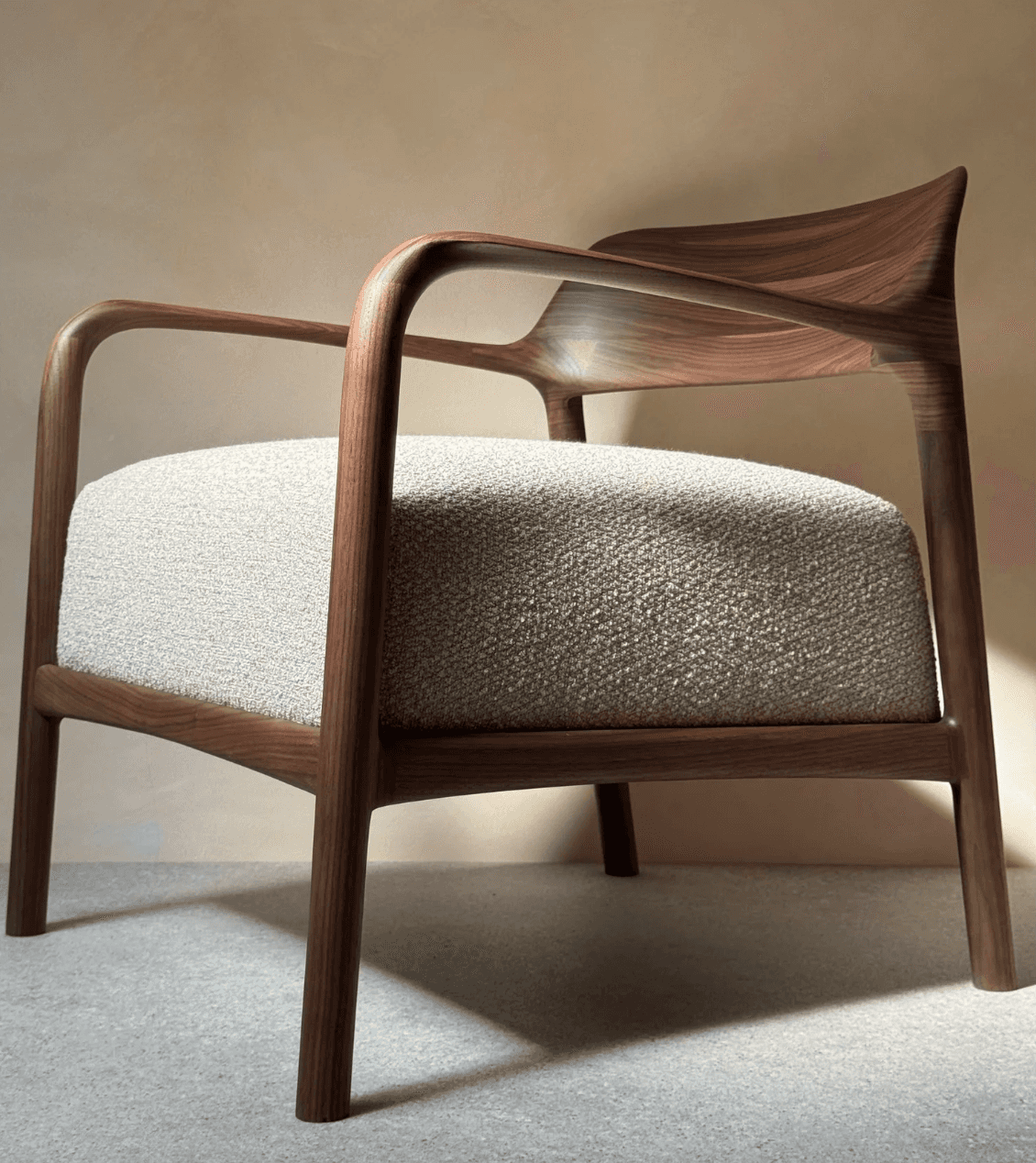 A contemporary armchair featuring a dark-stained walnut wooden frame with smoothly curved lines, int… — 3D model