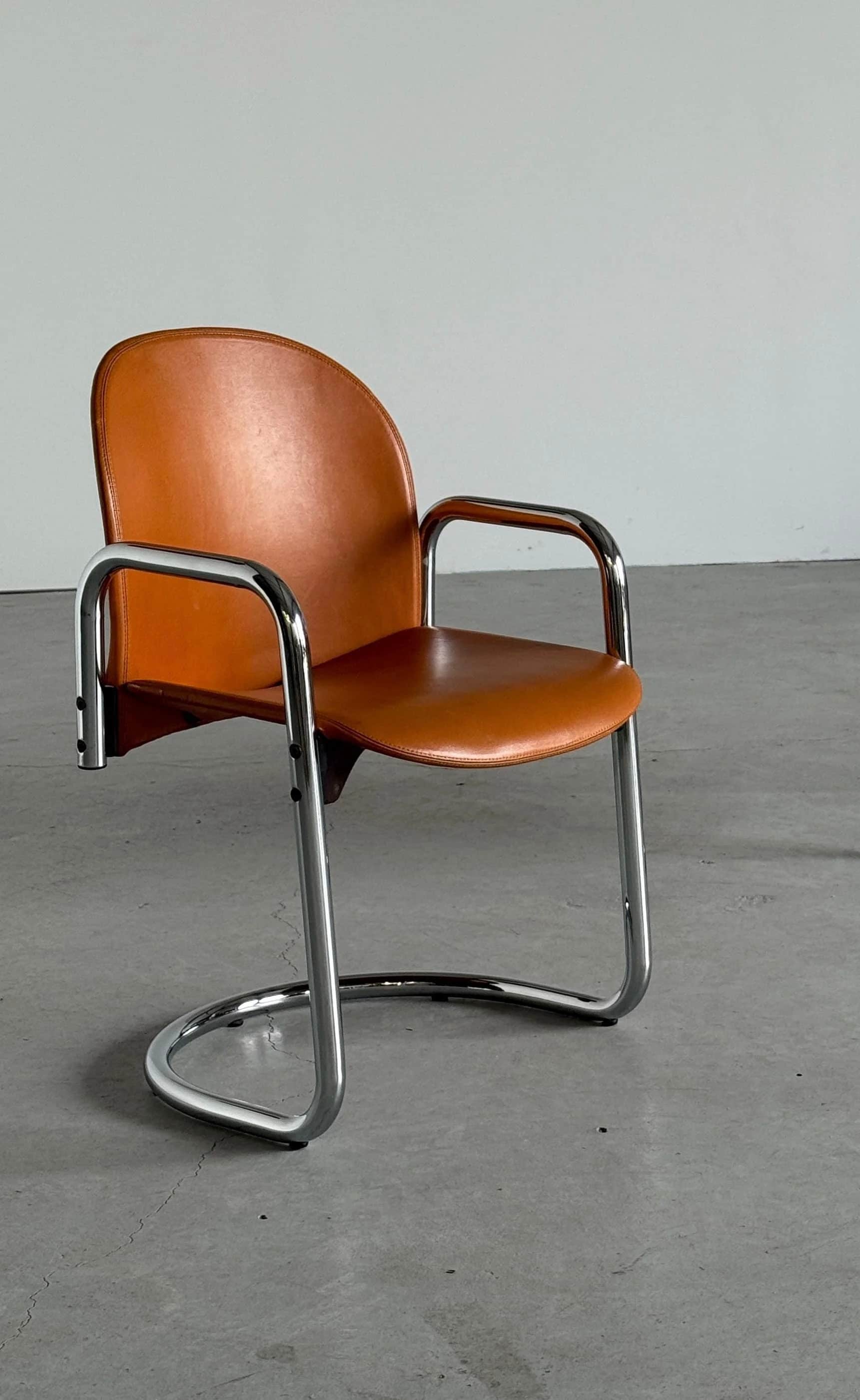 A modern armchair with a cantilever base, featuring a curved backrest and seat upholstered in brown… — free GLTF 3D model