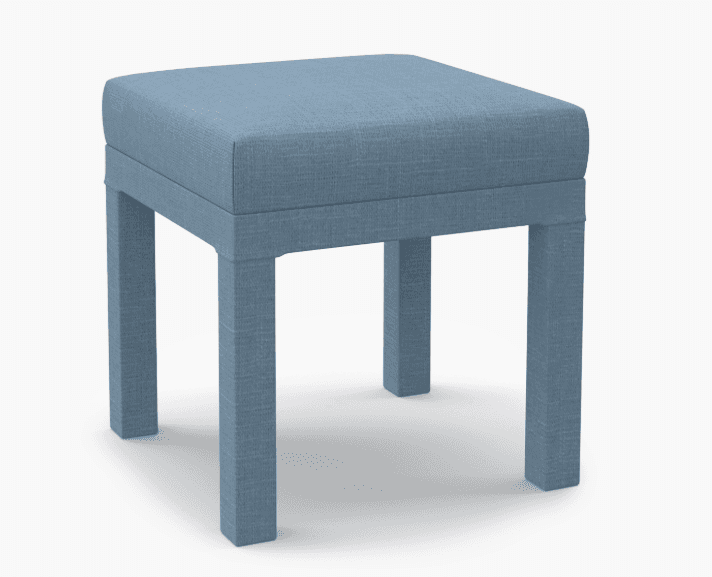A square upholstered ottoman with four straight legs. The ottoman is covered in a textured blue fabr… — 3D model
